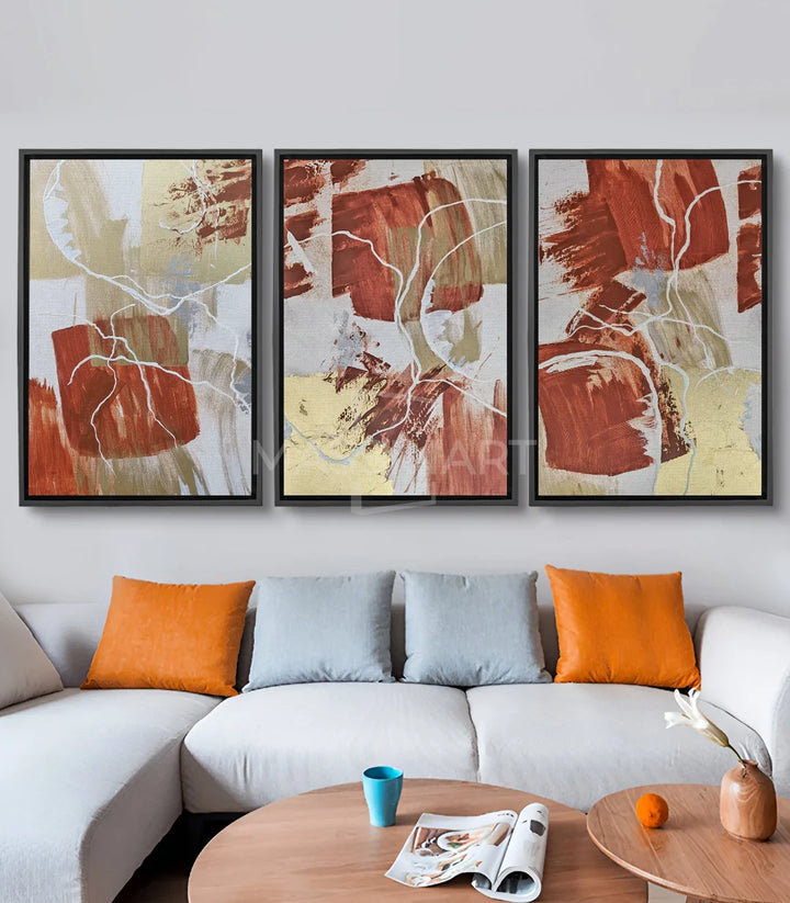 Cuadro hojas blancas fondo terracota ambientado en salón moderno Massinart