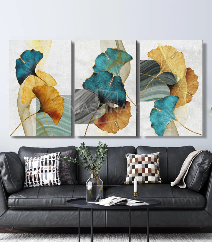 Ambiente salón moderno — tríptico Ginkgo Leaves sobre sofá negro, Massinart